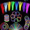 A collection of colorful glow sticks, including straws, rings, and bracelets, displayed against a black background.
