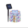 A spool of multicolored fairy lights is shown next to a solar panel for outdoor garden décor.