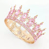 Gold-toned crystal rhinestone crown with pink stones and leaves.
