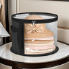 A black foldable hat storage box with a clear viewing window filled with stacked beige and pink knitted hats.