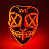 A glowing orange LED mask resembling a stylized face with crossed eyes and a wide grin.