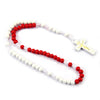 A rosary necklace made of wooden beads, including white and red beads, with a small wooden crucifix pendant.