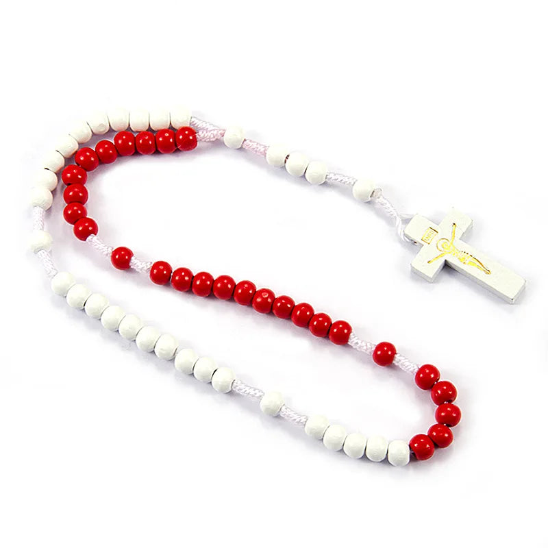 A rosary necklace made of wooden beads, including white and red beads, with a small wooden crucifix pendant.