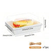 A white rectangular box with a clear lid holds a sliced pastry or sandwich, shown next to a measuring scale.