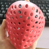 A hand holds a pink, perforated silicone mask designed as a realistic horror animal for Halloween costumes.
