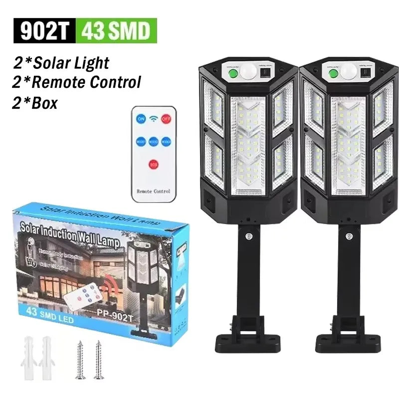 A set of solar-powered LED security lights, including two wall lamps and accessories like a remote control and box.