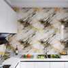 A kitchen countertop featuring a marble pattern self-adhesive backsplash panel with gold and gray veining.