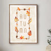 Wall art featuring the word AUTUMN decorated with watercolor autumn leaves and pinecones in a gold frame.