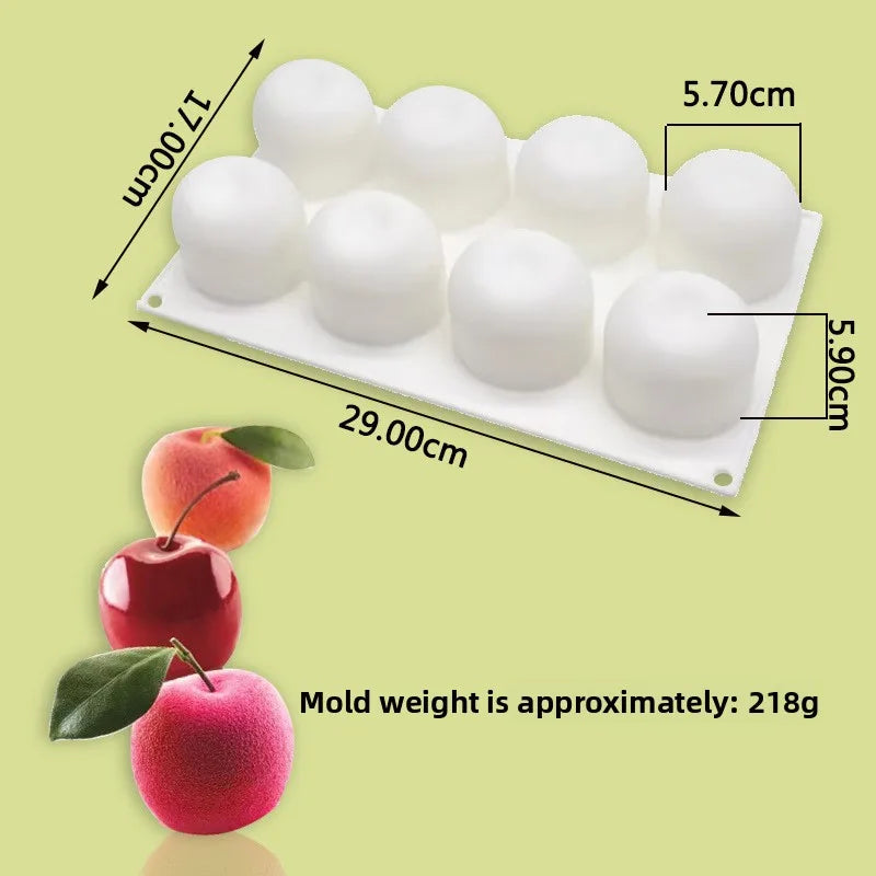 A white silicone mold with six cavities is shown next to a red apple, illustrating its size and use for dessert baking.