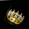 A gold-toned crystal rhinestone crown ring displayed against a black background.