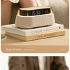 A beige wireless charging speaker lamp is shown on a wooden surface, illustrating relaxation at home.