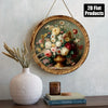 A round framed painting featuring a vintage floral arrangement and golden vase hanging on a light gray wall.