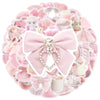 A circular arrangement of cute pink graffiti stickers and accessories for crafting