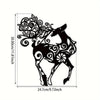 Black metal wall sculpture of a deer head with intricate scrollwork design