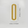 A polished gold house number shaped like the numeral zero with a self-adhesive backing.