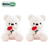 A pair of white bear plush toys with red faux flowers on their chests.