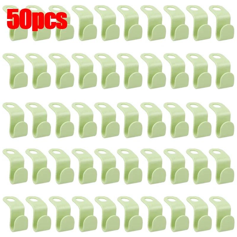 A set of 30 light green space-saving hanger connector hooks for organizing items.