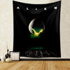 Black tapestry featuring a glowing green planet with a yellow atmosphere and the word ALIEN above it.