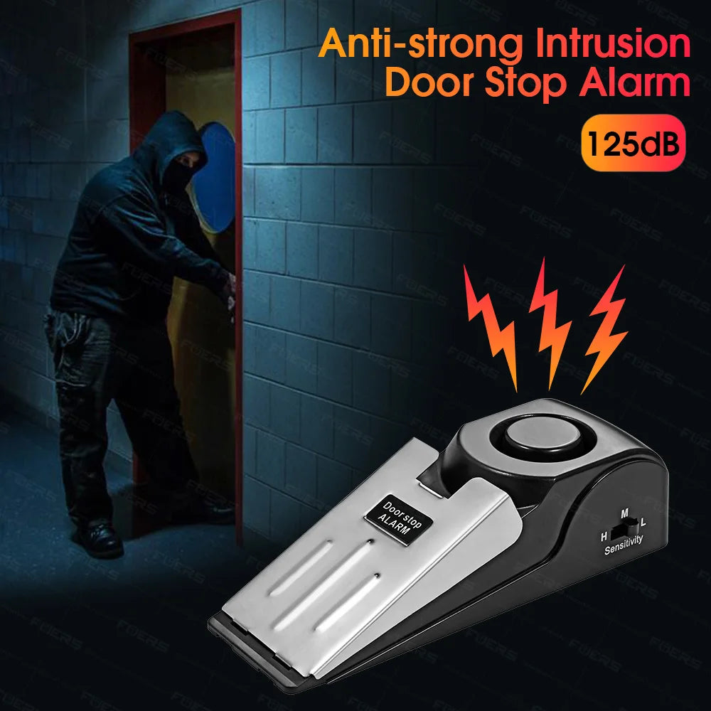 A black door stop alarm device is shown in front of a dark brick wall with a person partially visible through an open door.