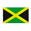A Jamaican flag tapestry featuring a green field with a yellow saltire and black quadrants.
