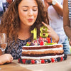 A close-up of a layered cake decorated with gold numbers 1 and 8 for a birthday celebration.