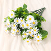 A bouquet of white daisies with green leaves arranged for home decor or events.