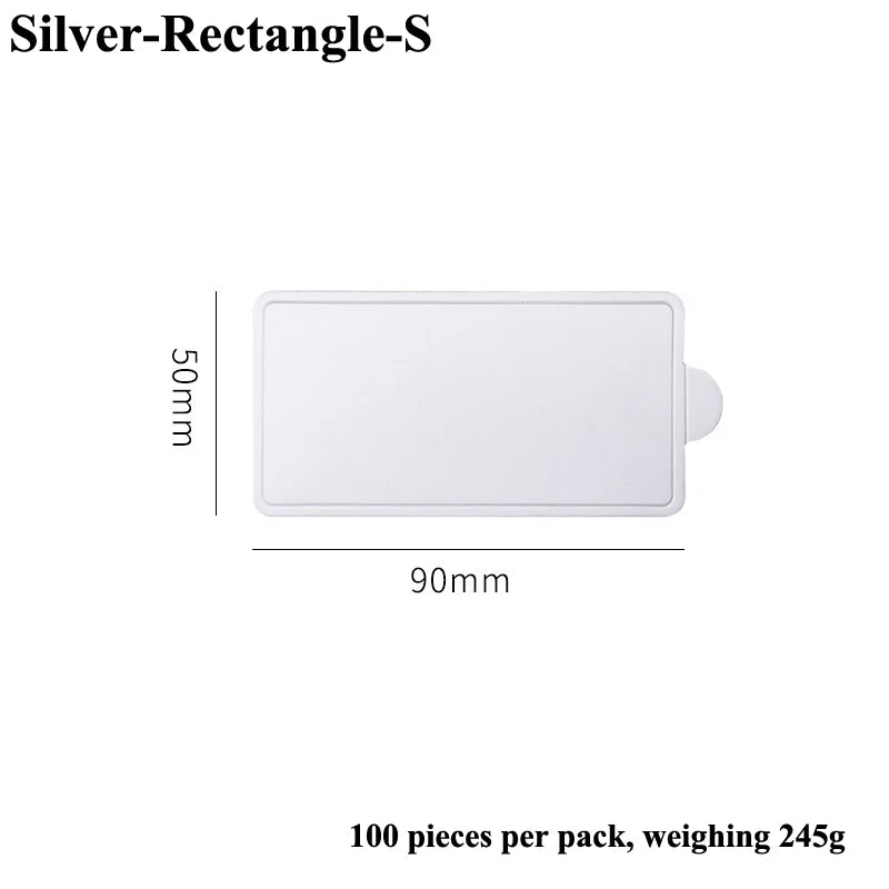 A white rectangular silver dessert cake board, 90mm by 50mm, shown flat.