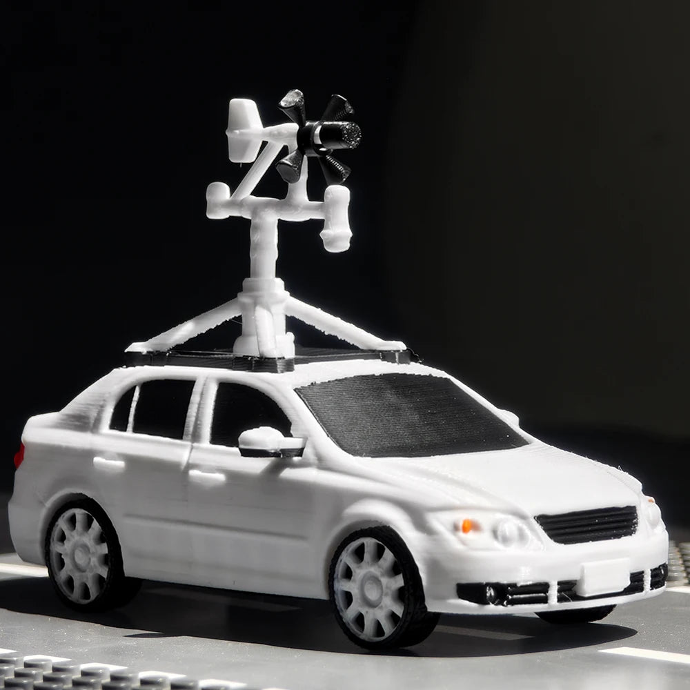 A white Tornado Intercept Vehicle 3D printed display model with an antenna mounted on top.