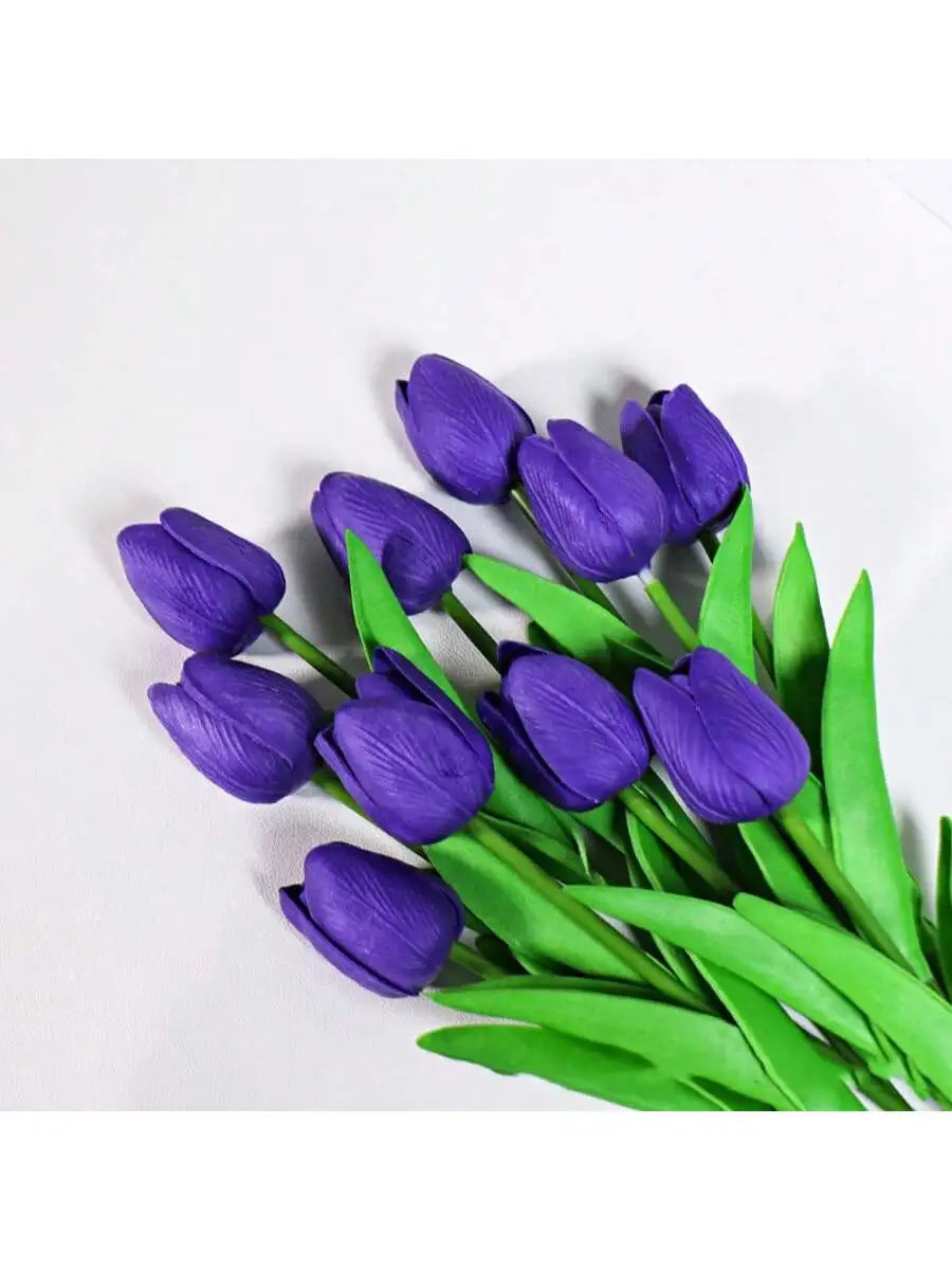 A bouquet of six vibrant purple artificial tulips with green leaves.