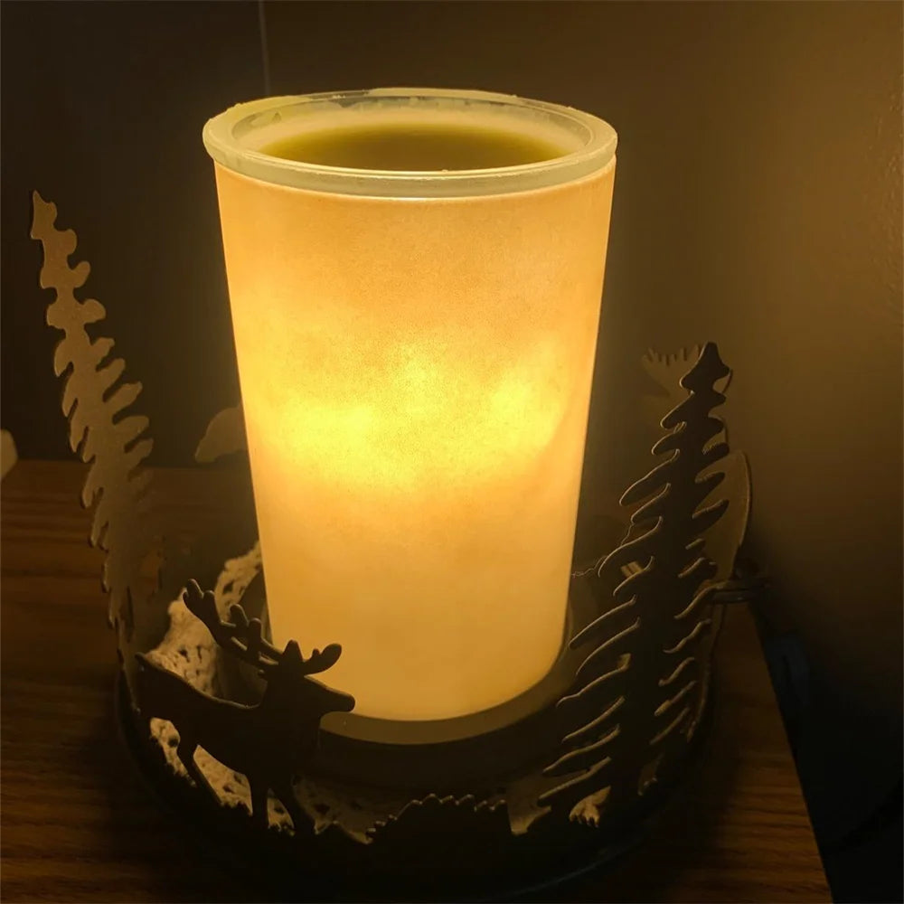A glass candle holder with a glowing yellow light sits on a dark surface.