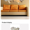A sofa in a light beige color is positioned below a wall decorated with a circular mirror art set.