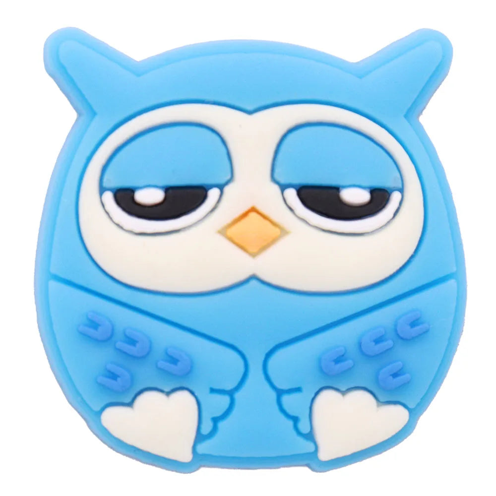 A cute blue owl PVC shoe charm featuring large eyes and detailed feathers.