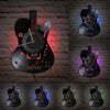 A collection of vintage vinyl record guitar wall clocks displayed against a brick background.