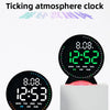 A black LED ambient light clock displaying 12:52 with a ticking atmosphere design.