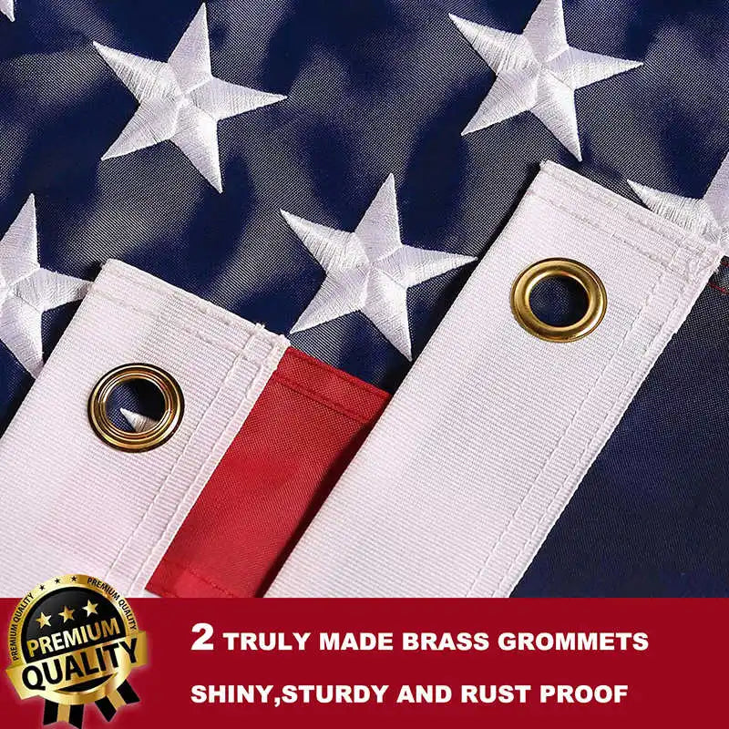 Two white embroidered American flags with brass grommets on a dark blue fabric background