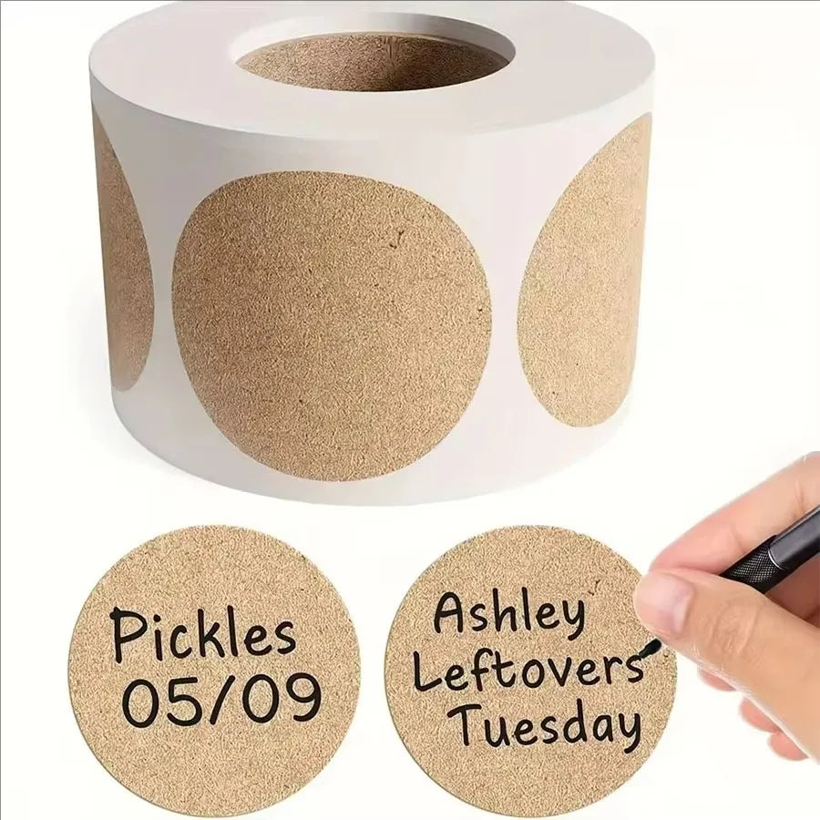 A white cylindrical paper seal label dispenser with round kraft paper labels showing the date 05/09 and the word Tuesday.