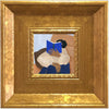 A painting of a person reading a blue book, framed in an elegant gold picture frame.