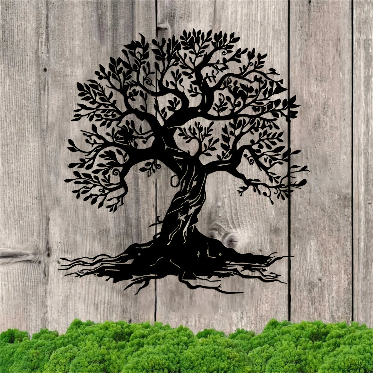 Black silhouette of a large tree with roots on weathered wooden planks above green foliage