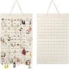 A white felt earring organizer display with numerous jewelry pieces hanging on pegs.