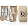 An open leather case displaying an 8-piece stainless steel manicure and pedicure kit with various tools.