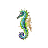 A vintage marine life brooch pin set featuring a turquoise and green dragon-like creature with gold accents.