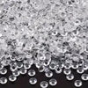 A pile of clear, round resin rhinestones in various sizes and colors.