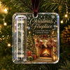 Clear acrylic ornament featuring a Christmas fireplace scene with a decorated tree and gifts.
