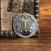 A commemorative coin of Saint Michael the Archangel featuring winged figures and a central shield design.