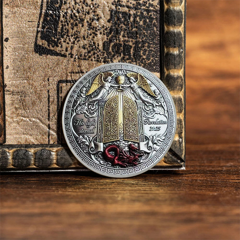 A commemorative coin of Saint Michael the Archangel featuring winged figures and a central shield design.