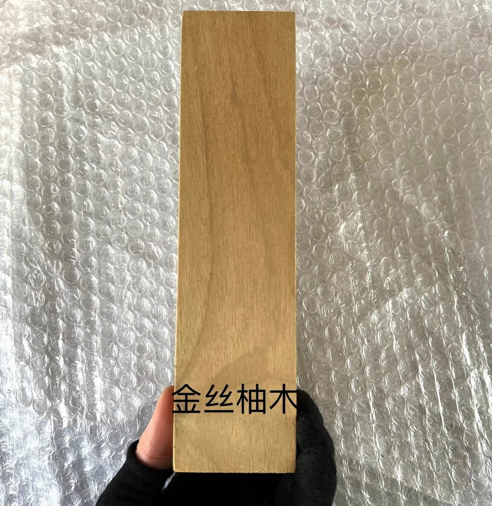 A vertical blank of natural wood, used for knife handles and DIY projects.
