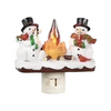 A decoration featuring two snowmen with hats and a flickering campfire light.