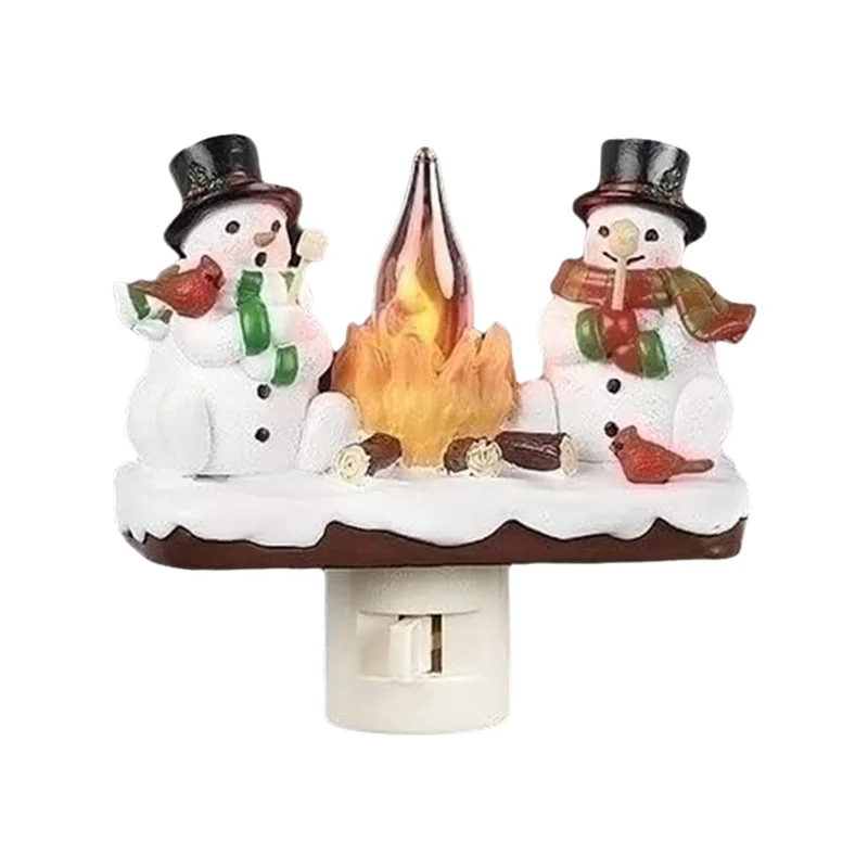 A decoration featuring two snowmen with hats and a flickering campfire light.