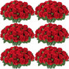 A bouquet of red artificial silk roses in a green arrangement.