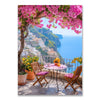 A vibrant scene of a Mediterranean town with white buildings overlooking the sea and pink blossoms under a lush tree.